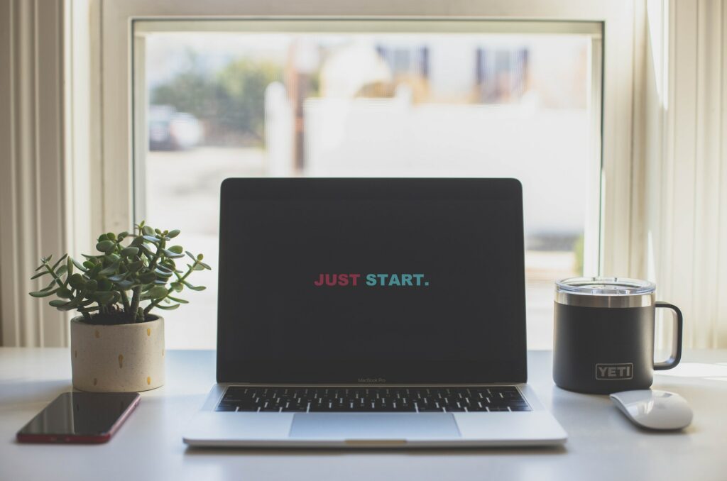 Laptop with words Just Start on it. Photo by dayne-topkin-y5_mFlLMwJk-unsplash