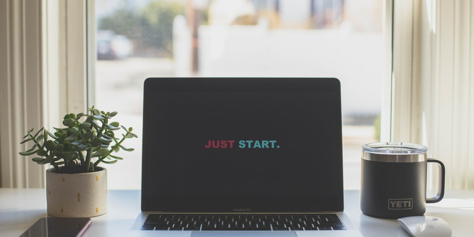 Laptop with words Just Start on it. Photo by dayne-topkin-y5_mFlLMwJk-unsplash