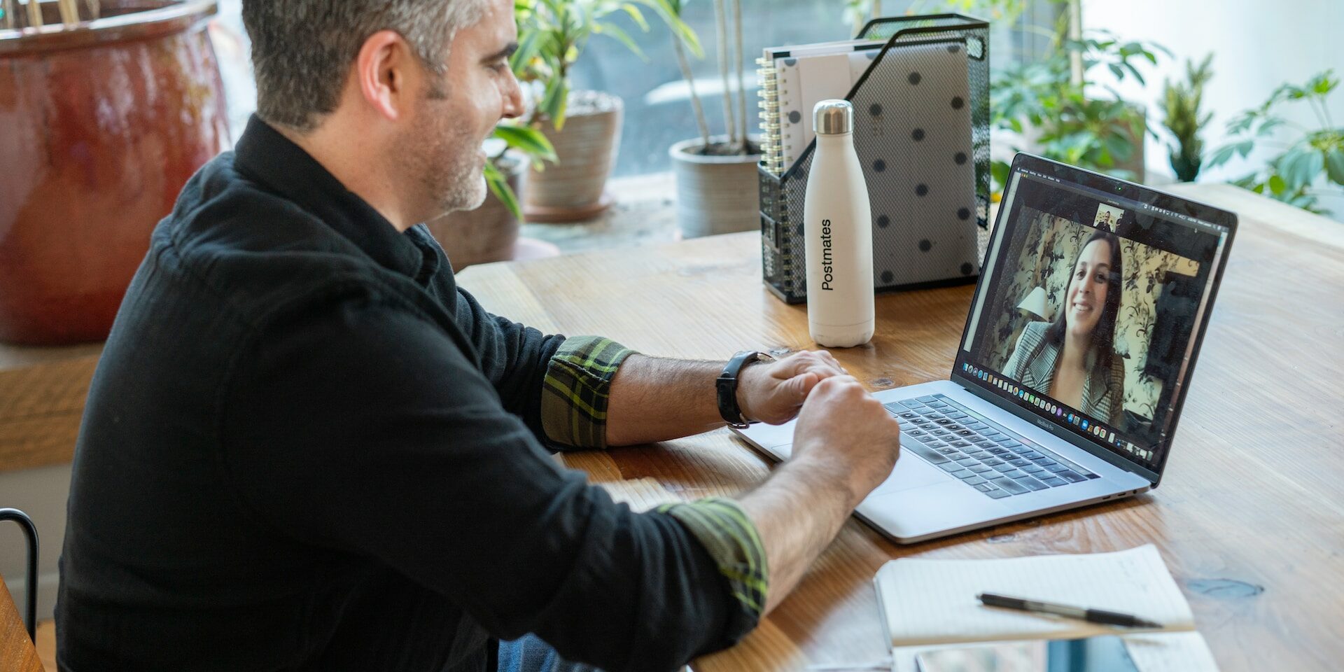 man sitting in front of a computer on a Zoom Call.